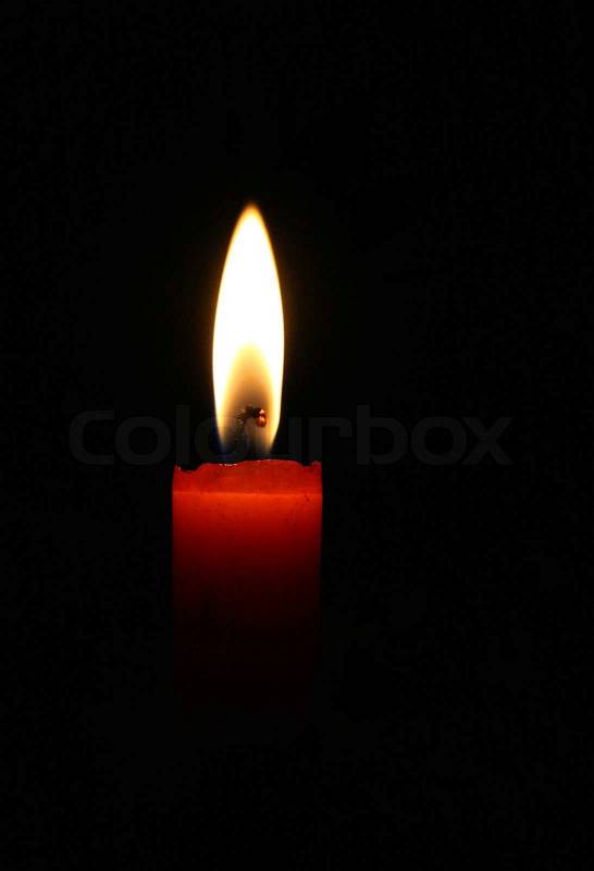 Stock image of 'Blazing red candle in the night'