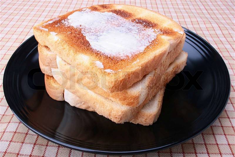 1991956-65398-toasted-white-bread-with-butter-on-a-black-plate.jpg