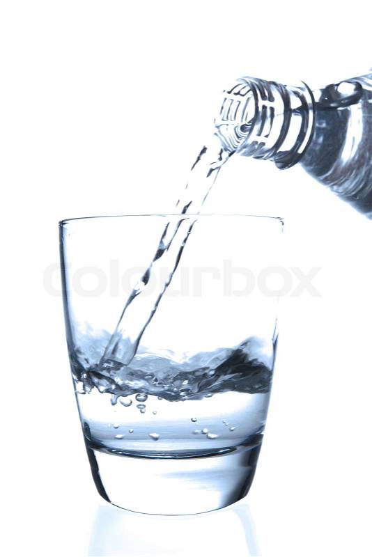 Stock image of 'Pouring water from a bottle to a half filled glass'