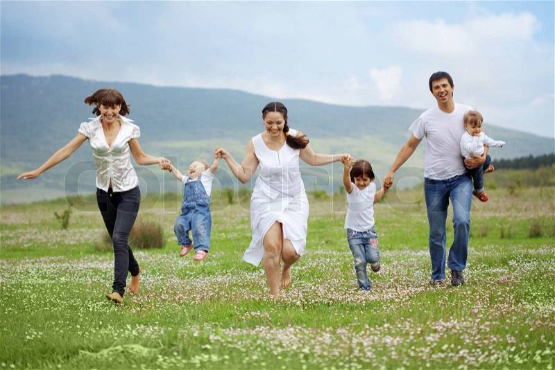 2722725-626270-group-of-happy-parents-with-children-running-in-field