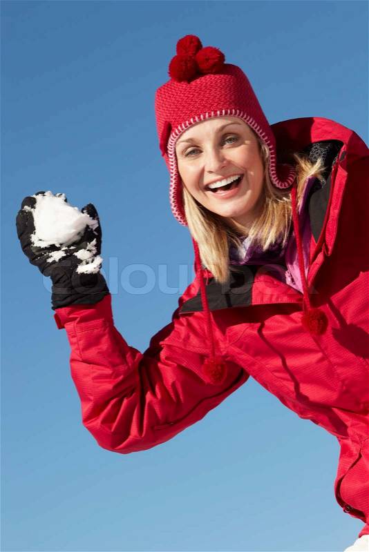 4314922-950432-woman-about-to-throw-snowball-wearing-warm-clothes-on-ski-holiday-in-mountains.jpg