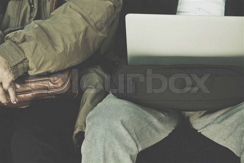 Businessman sitting on seat of train and playing Laptop, stock photo