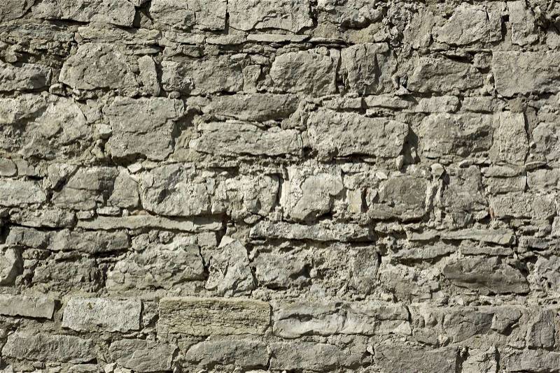 Fragment of a wall relief ancient fortification with large boulders in sunny day, stock photo