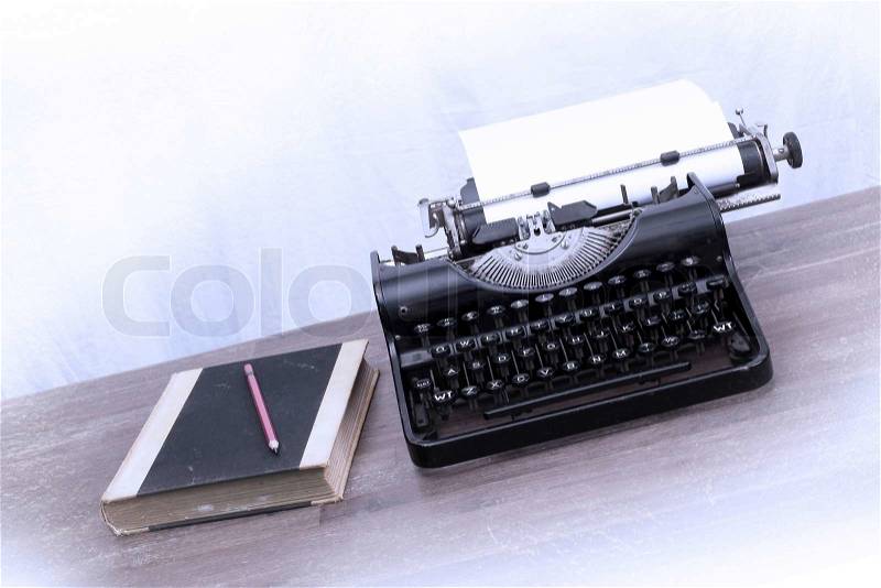 Vintage typewriter and old books, touch-up in retro style, stock photo