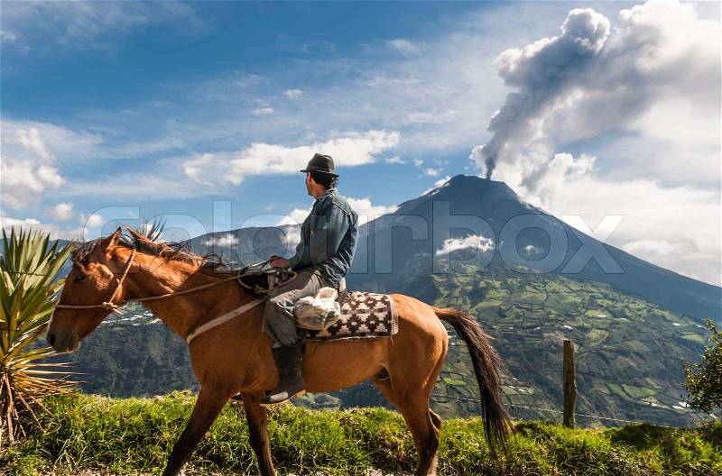 BANOS, ECUADOR - DECEMBER 10: Unrecognizable farmer on a horse looking at the Tungurahua volcano eruption - december 10, 2010 in Banos, Cordillera Occidental of the Andes of central Ecuador, South America , stock photo