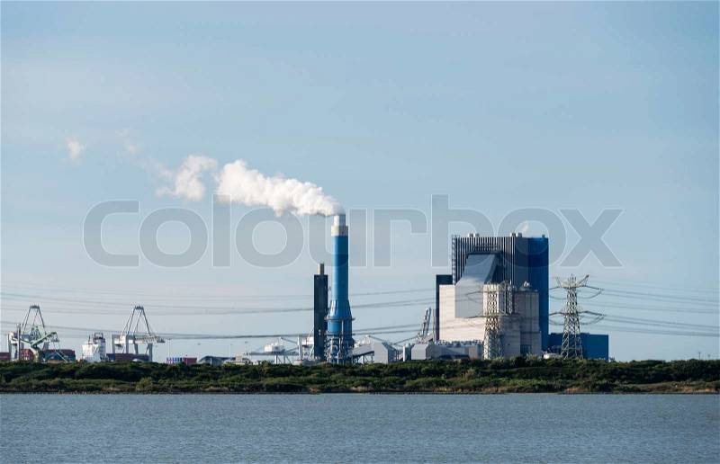 Industrial skyline with cranes and power plant in Holland europoort, stock photo