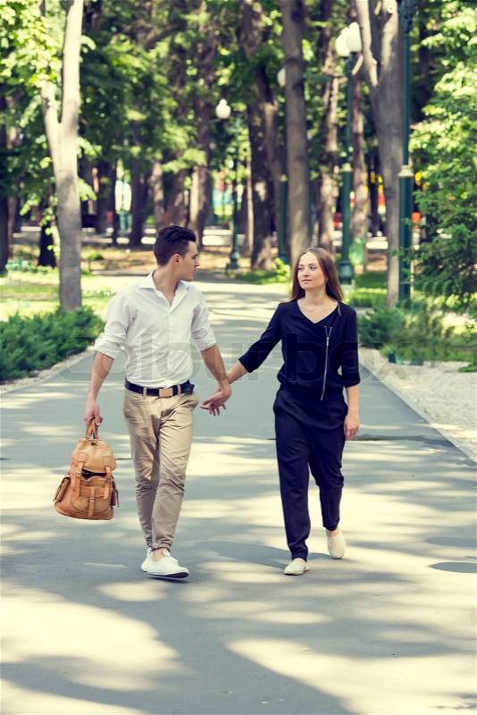 Man and woman walking in the park, stock photo