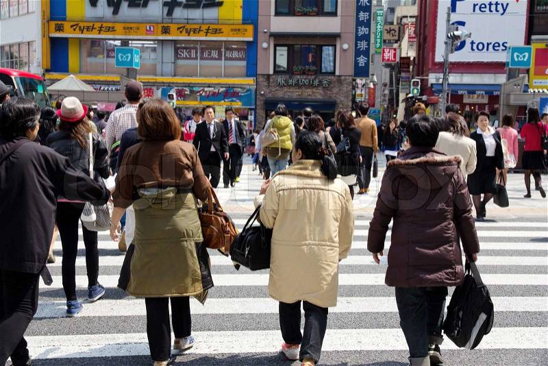 Tokyo, Japan - April15, 2014 : Tourists and business people crossing the street at Shibuya in April15, 2014, the most important commercial center in Tokyo, Japan, stock photo