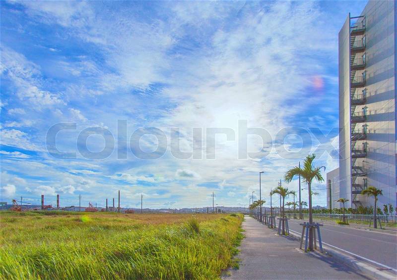 Asphalt road and blue sky with clouds, stock photo