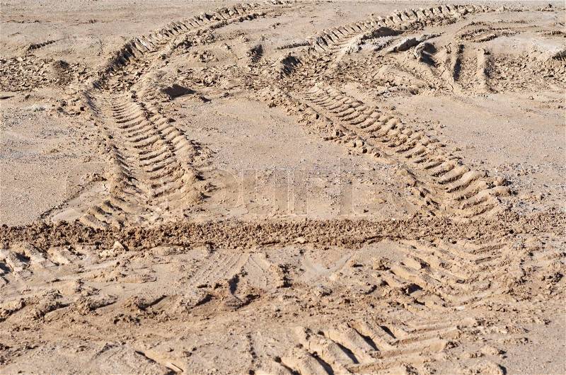 Traces of the wheel off-road truck tire on the dried soil, stock photo