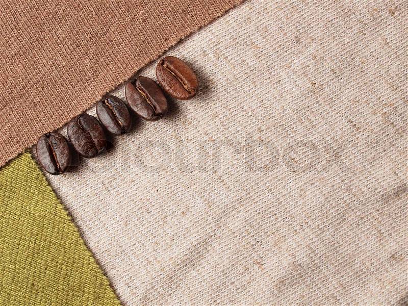 Roasted Coffee Crop Beans on fabric textile, stock photo