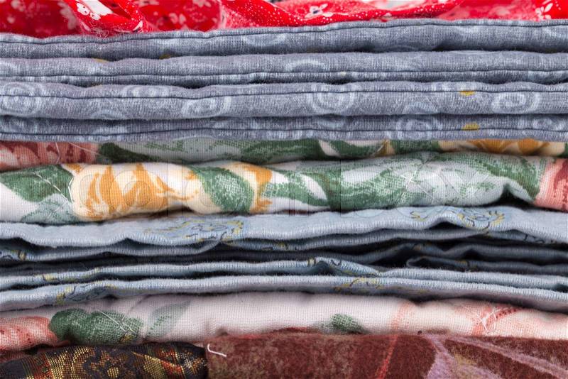 Stack of color clothes stored in rows. Whole background, stock photo