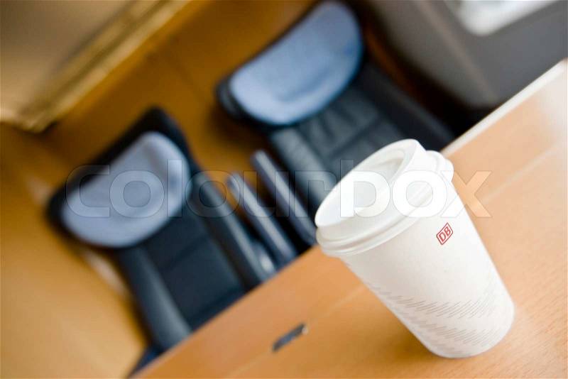 Plastic coffee cup on a german train, stock photo