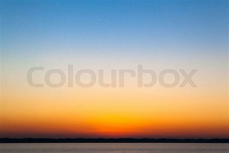 Blue and orange gradation of sunset on the lake Kasumigaura, stock photo