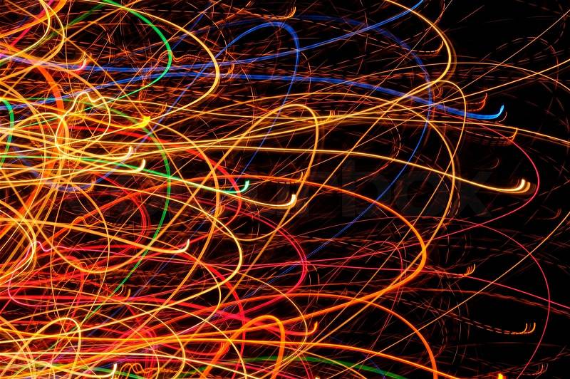 Abstract multicolored bright glowing lines and curves against a black background, stock photo