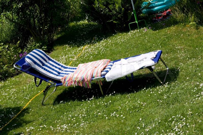 Folding bed out in a garden, stock photo