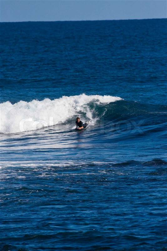 A man surfing in Australia, stock photo