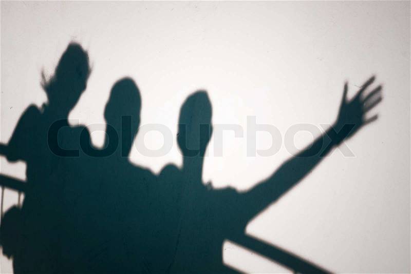 Creative photo of three people shadows on white wall gesturing, stock photo