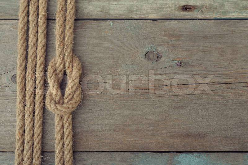 Ship rope on old wooden background with copy space, stock photo