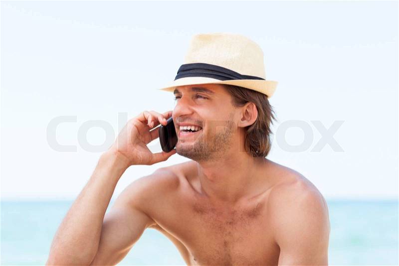 Man cell phone call smile on beach summer vacation, Handsome young male wear hat, guy over sea blue sky, communication concept ocean holiday travel, stock photo