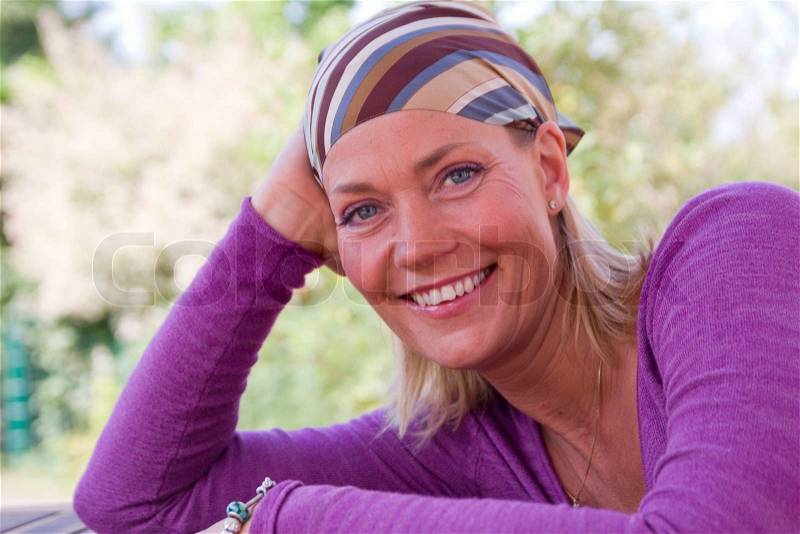 A smiling cancer free caucasian woman with bandana, stock photo