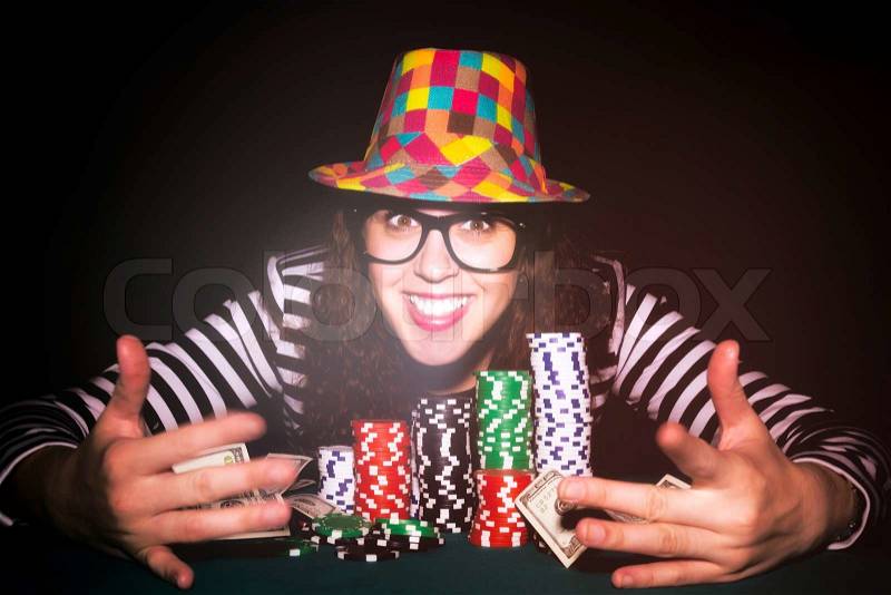 Happy female face on the poker table.Selective focus on the female, stock photo