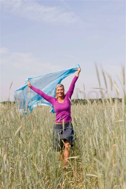Cancer-free woman in the field, stock photo