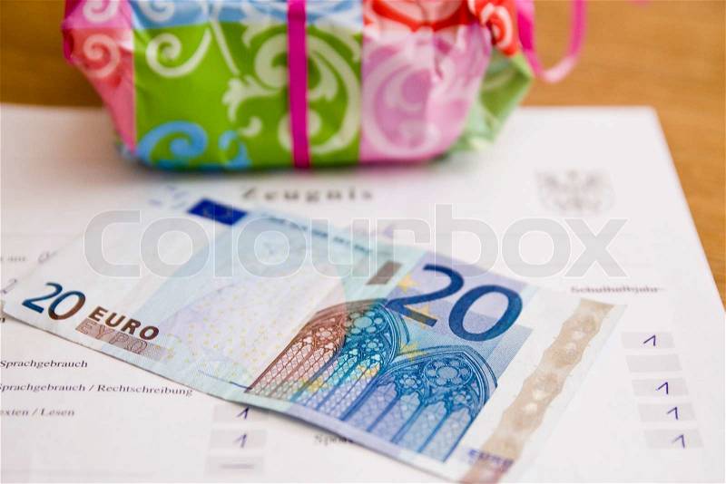 Present and euro bills as reward for good grades in school, stock photo