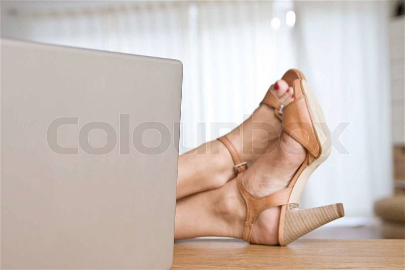 Feet of a woman relaxing on a table, stock photo