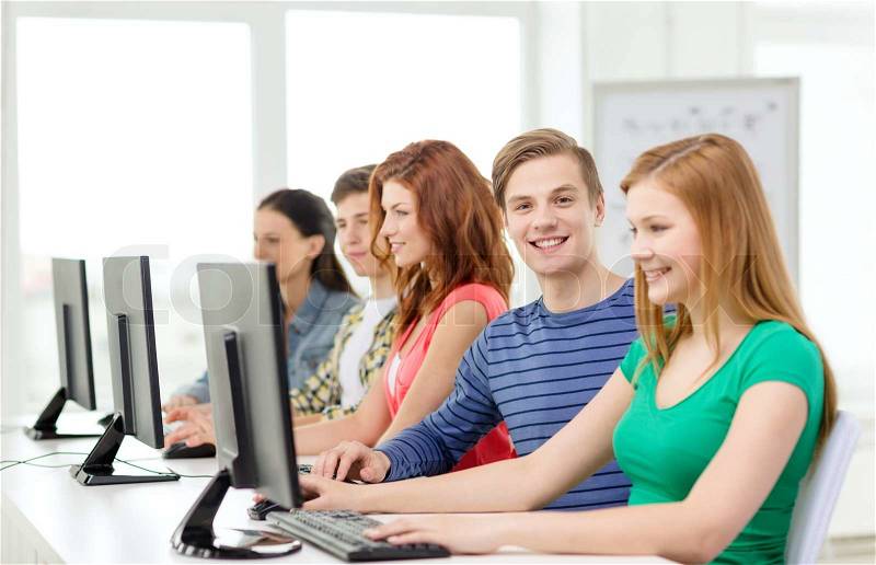 Education, technology and internet - smiling male student with computer studying at school, stock photo