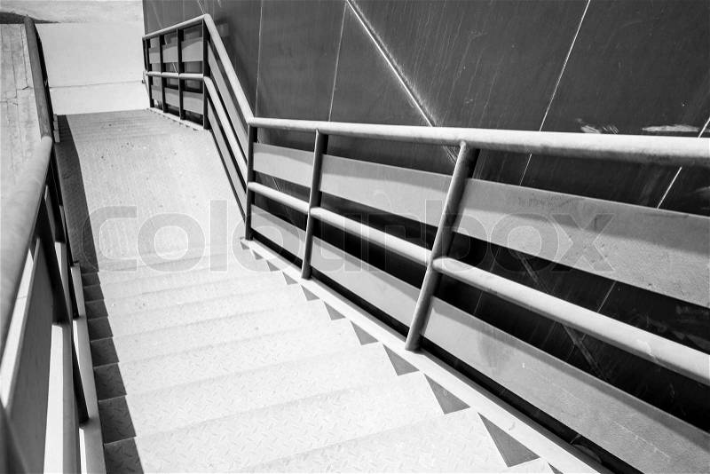 Industrial metal staircase perspective. Black and white photo, stock photo