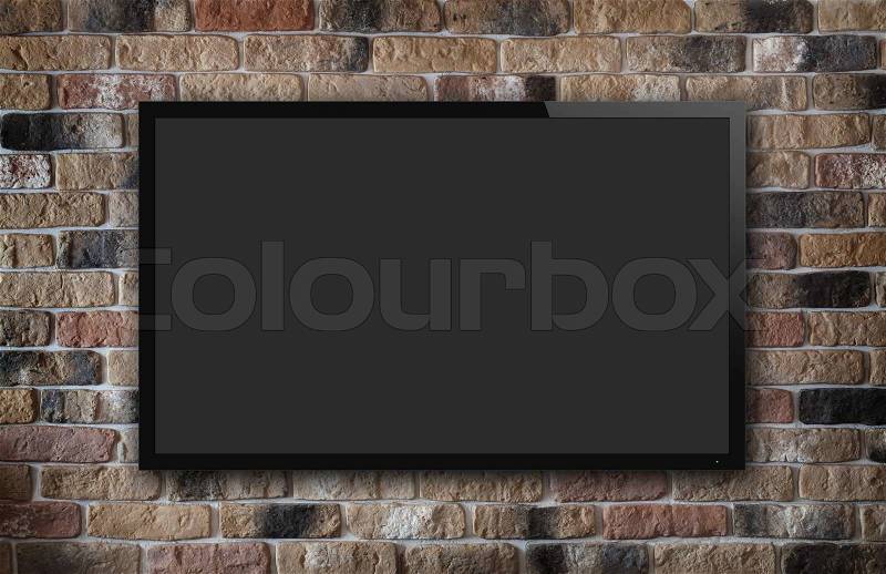 TV display on old brick wall background, stock photo