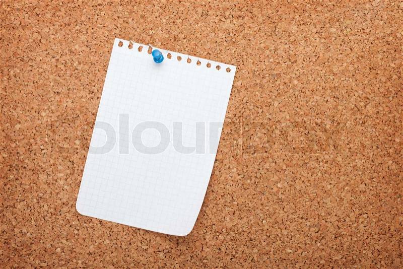 Blank notepad paper on cork wood notice board with copy space, stock photo