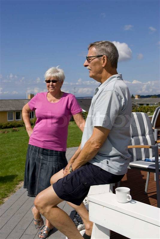 An elderly couple enjoying their summer holiday, stock photo