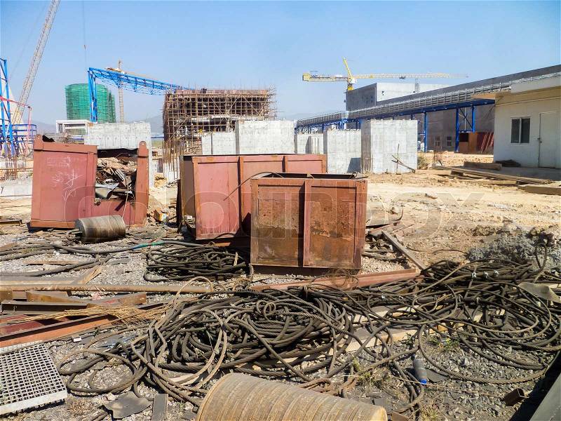 Messy construction site- many wire, cable, metal box, containers, stock photo