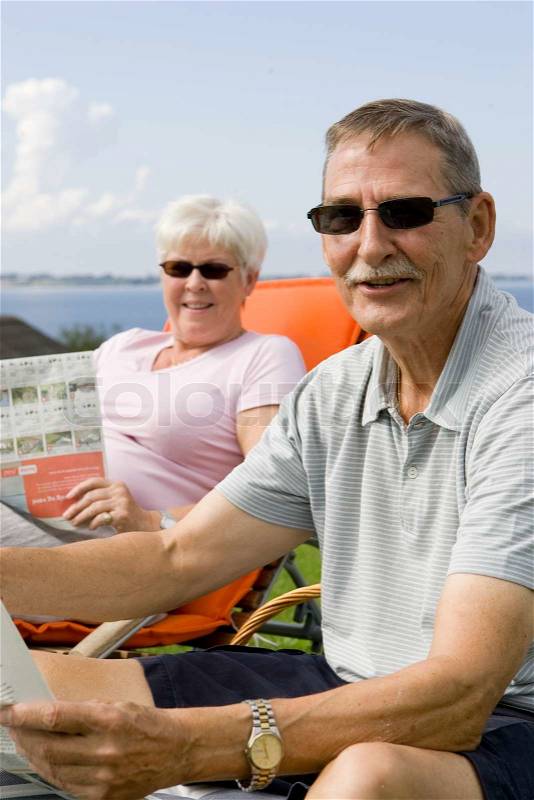 An elderly couple enjoying their summer holiday, stock photo