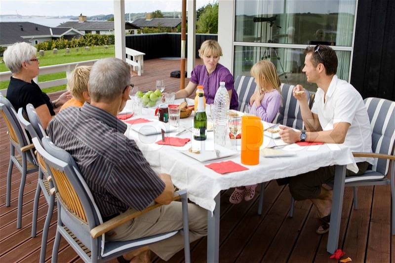 A caucasian family having outdoor breakfast, stock photo