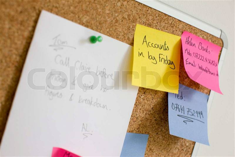 Corkboard with post-it notes, stock photo