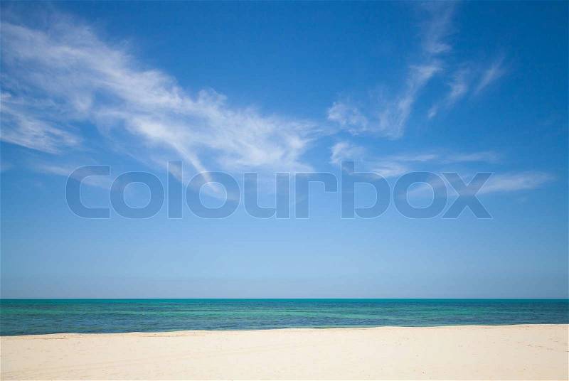 Beautiful cloudy sky over white sandy beach. Nature background, stock photo