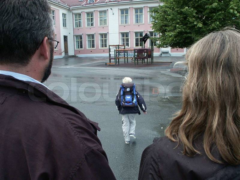 Parents sending their son to his first day of school, stock photo