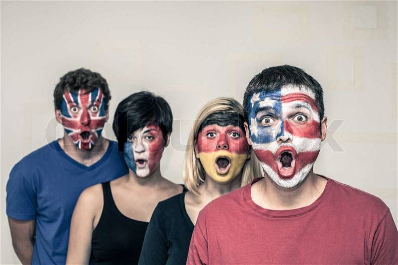 Group of surprised people with painted flags on their faces, stock photo
