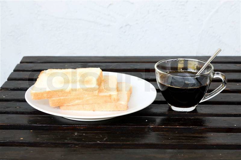 Plate with a cup of coffee and bread, stock photo