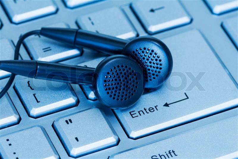 Headphones and computer keyboard, concept of digital music , stock photo