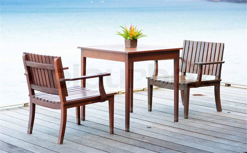Terrace sea view with outdoor wood chairs and table, stock photo