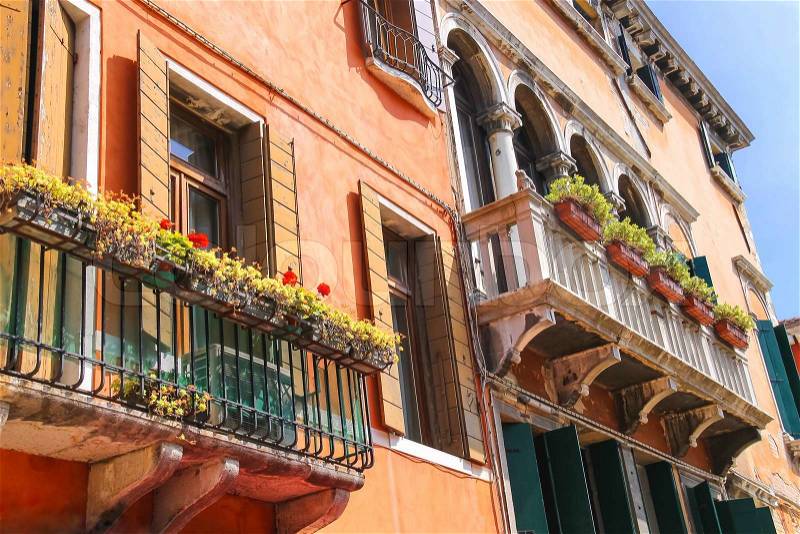 Picturesque Italian house with flowers on the balconies, stock photo