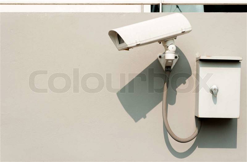 Surveillance security camera outside the building, stock photo