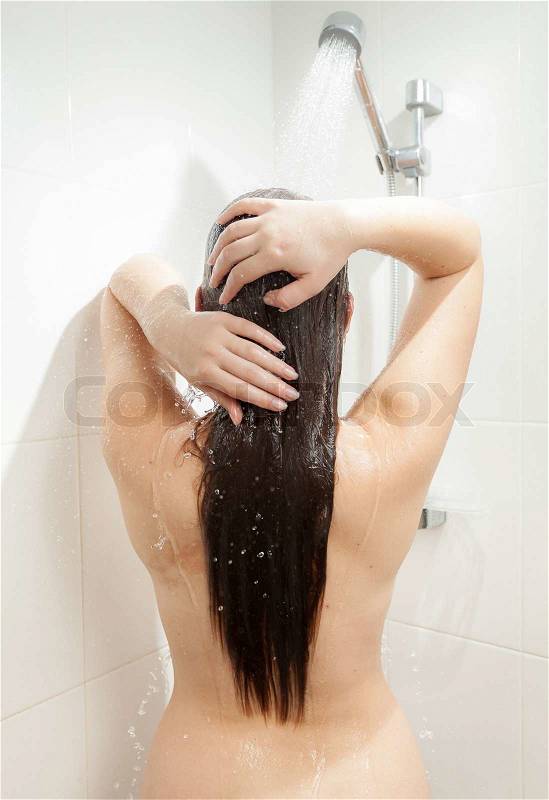 Closeup photo from back of brunette woman washing head, stock photo