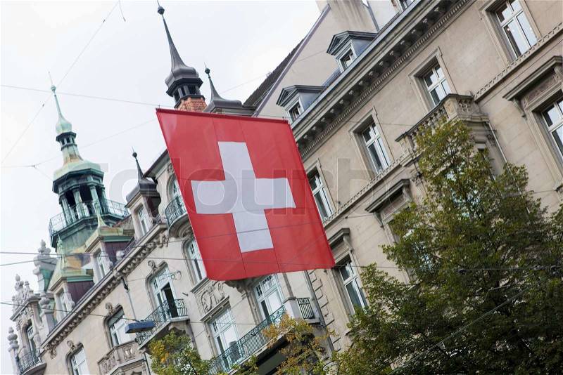 Swiss flag hanging along a Zurich street, stock photo