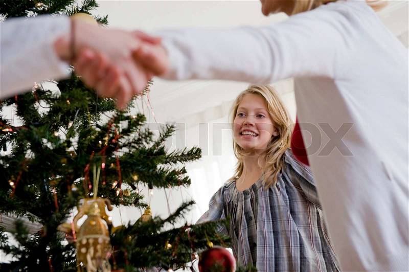 Caucasian family dancing around the Christmas tree, stock photo