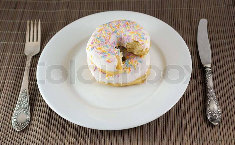 Donut with chunk bitten off, stock photo